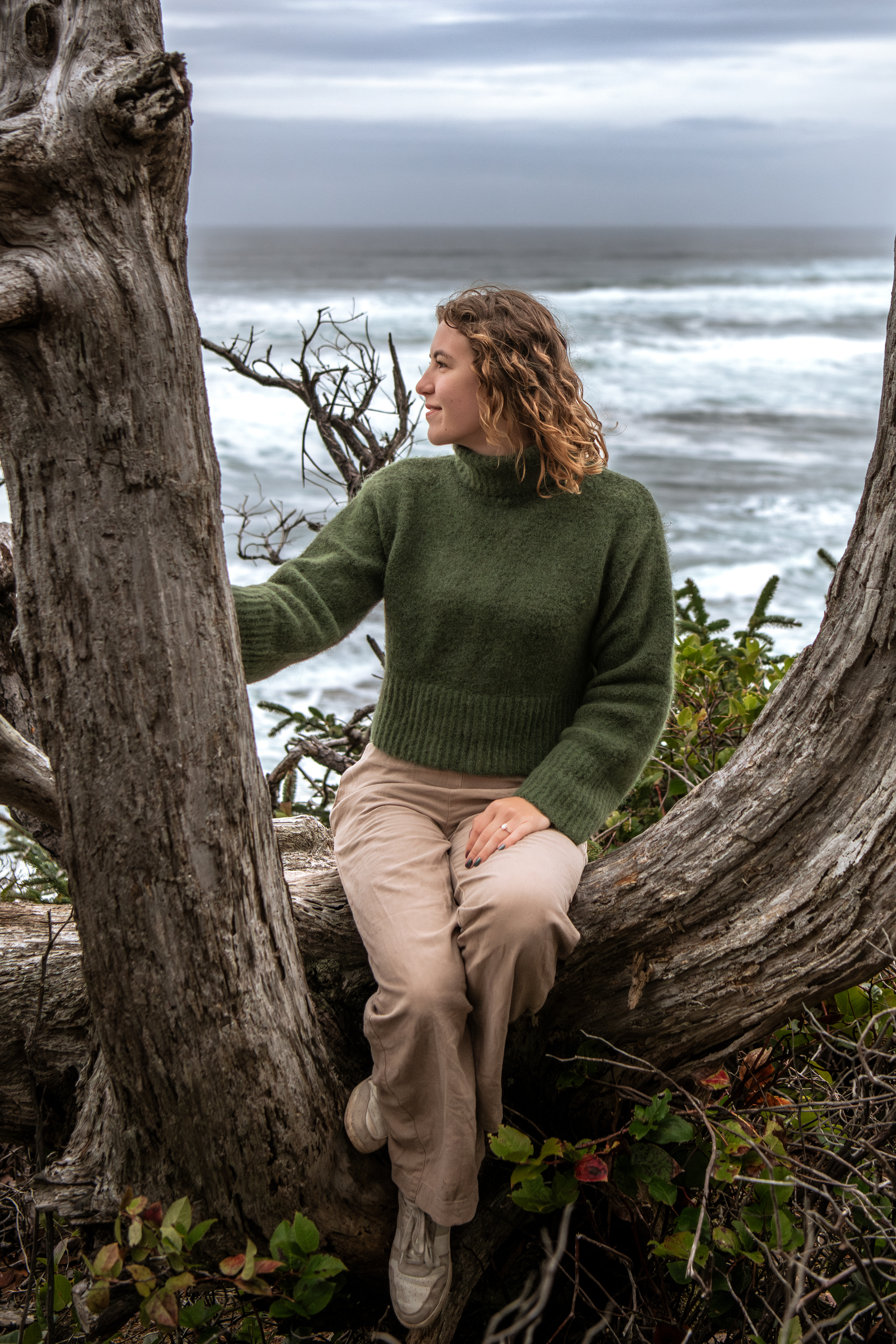 Aryah Seed sitting on a log.